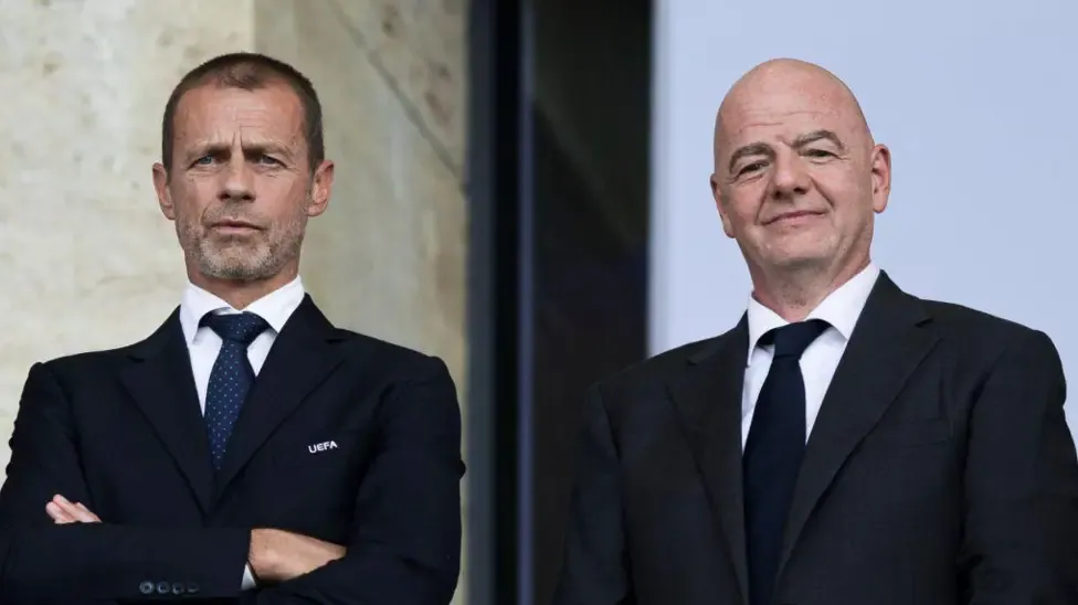 Uefa president Aleksander Ceferin and Fifa president Gianni Infantino look o from the stands during a football match