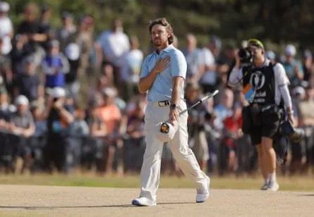 Tommy Fleetwood puts a hand to his heart as he walks up the fairway on the 18th hole on Sunday