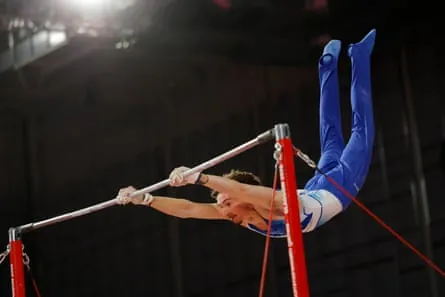 Reuben Ward performs on the high bar.