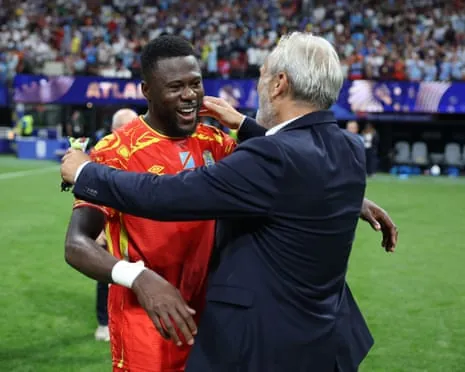 Chancel Mbemba huges Sébastian Desabre after the Democratic Republic of the Congo beat Uzbekistan to qualify for the World Cup last 32