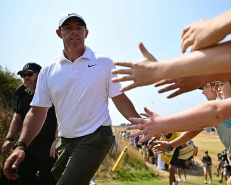Rory McIlroy interacts with fans as he leaves the 13th green