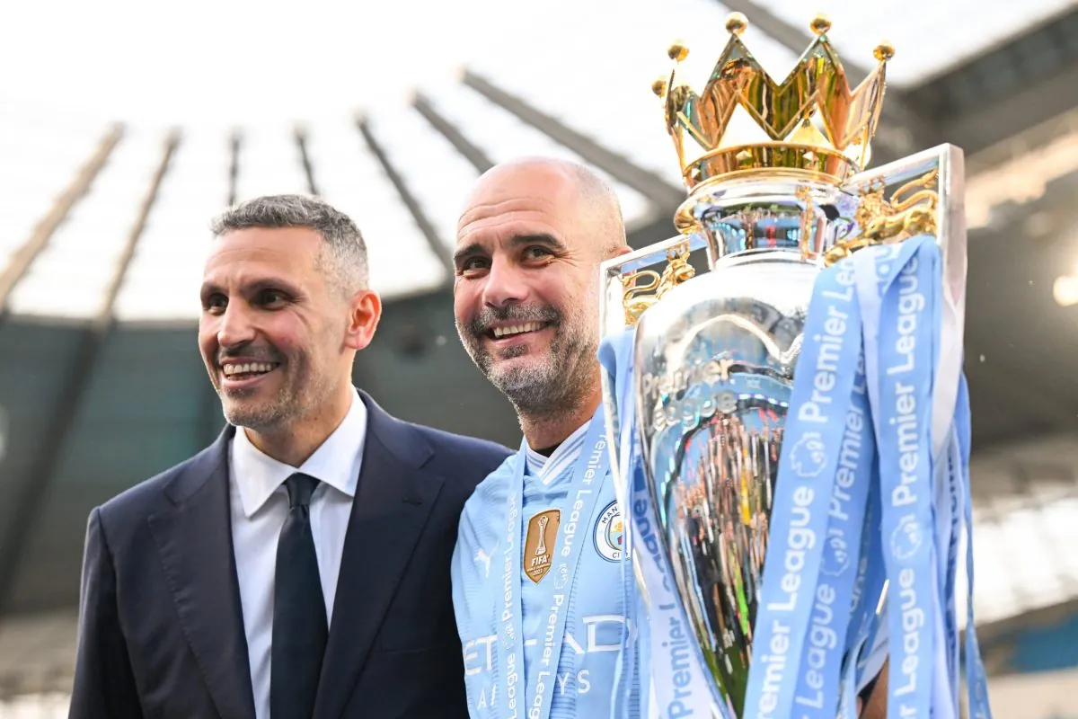 MANCHESTER, ENGLAND - MAY 19: MANCHESTER, ENGLAND - MAY 19: Khaldoon Al Mubarak, Chairman of Manchester City, and Pep Guardiola, Manager of Manchester City, poses for a photo with the Premier League title trophy following the team's victory in the Premier League match between Manchester City and West Ham United at Etihad Stadium on May 19, 2024 in Manchester, England. (Photo by Michael Regan/Getty Images)